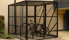 Secure single steel mesh bicycle storage shelter.