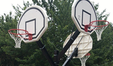 Triple steel playground in ground basketball goal posts.