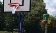 Outdoor mixed playground in ground basketball goal posts.