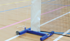 Freestanding indoor tennis posts with winder.